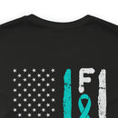 Courage Unveiled: Distressed US Flag with Teal Ribbon PTSD Cotton T-Shirt